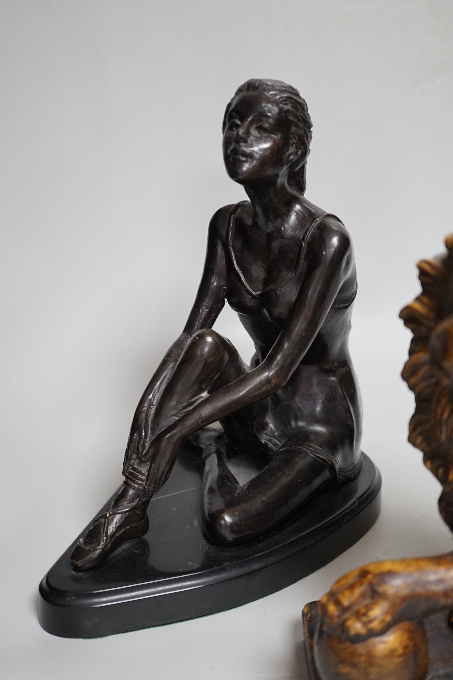 A bronze figure of a seated female dancer and a model of a lion, dancer 29cm high